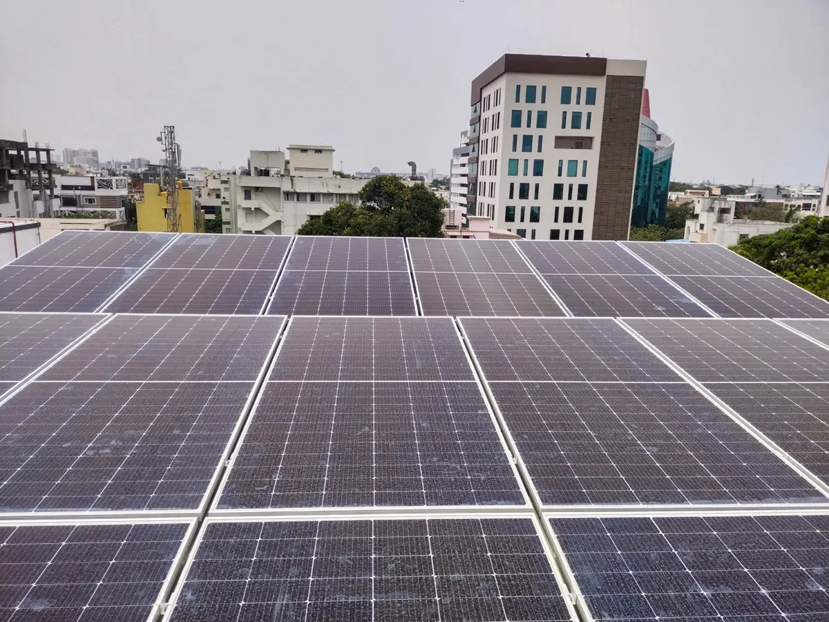 Rooftop solar panel installation with city skyline